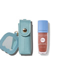 Light blue lip balm case and lip balm with visible brand name on a white background