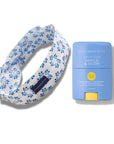 Floral-patterned neck pillow and blue sunstick with 'Bloomeffects' branding on a white background