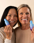 Two smiling models holding Black Tulip Regenerative Serum