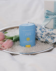 Blue skincare product with floral elements on a tray