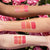 Swatches of lip oil on arms with different skin tones