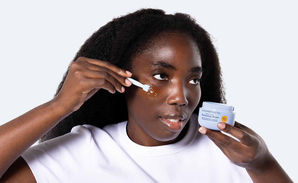 Woman applying Bloomeffects Nectar to her face